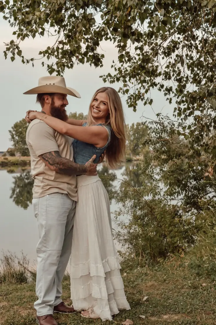 Couple embracing by the water during their session